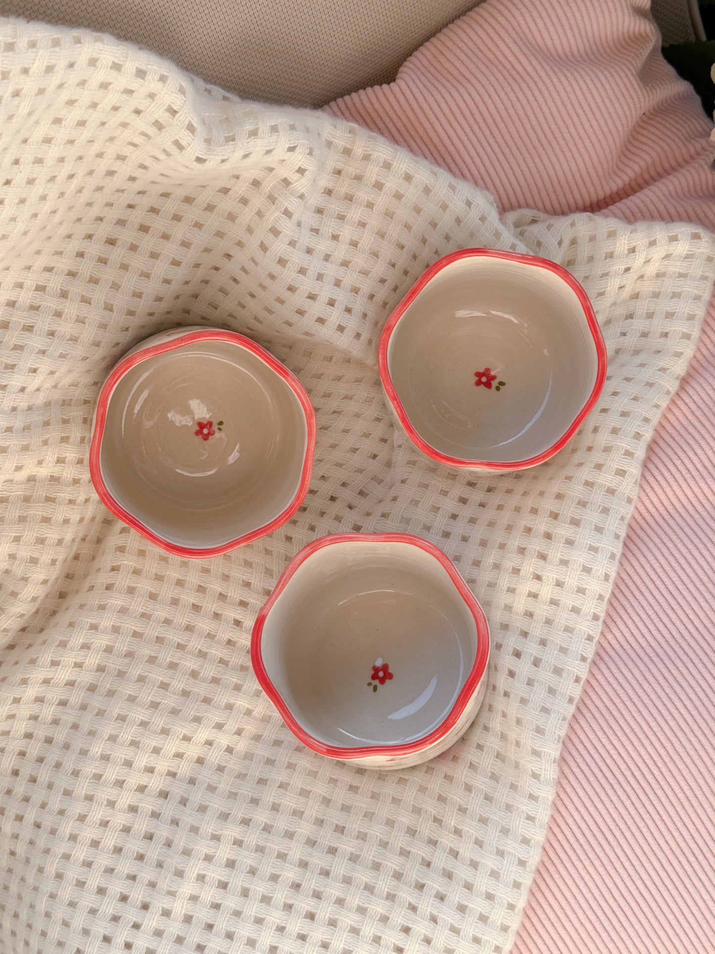 Cup with cherries and red flowers