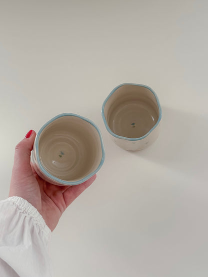 Cup with blue tulips