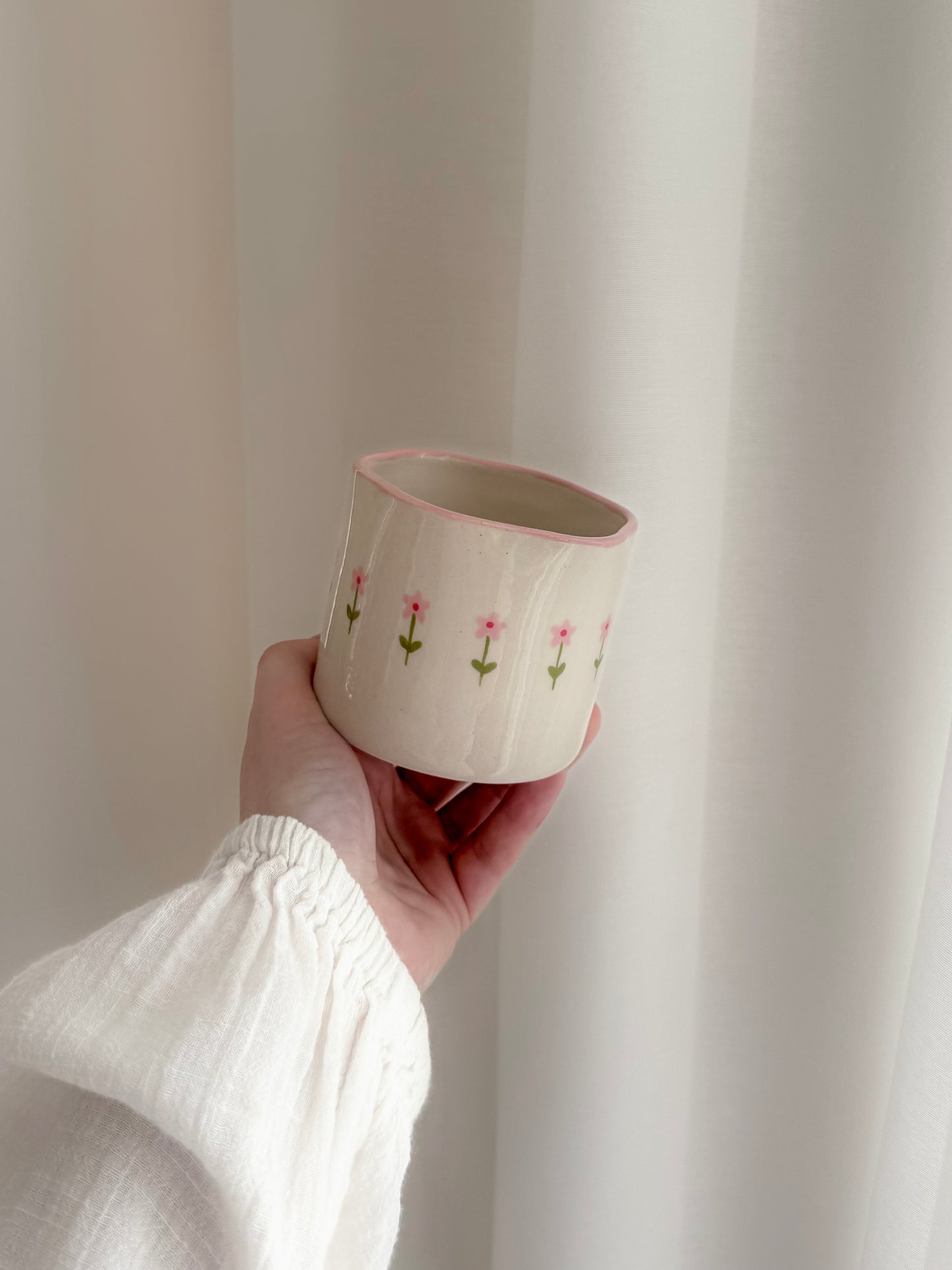 Cup with small pink flowers