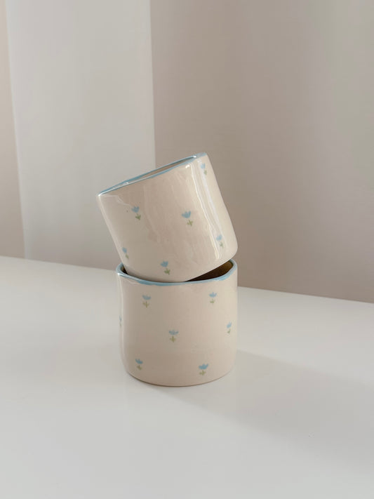 Cup with blue tulips