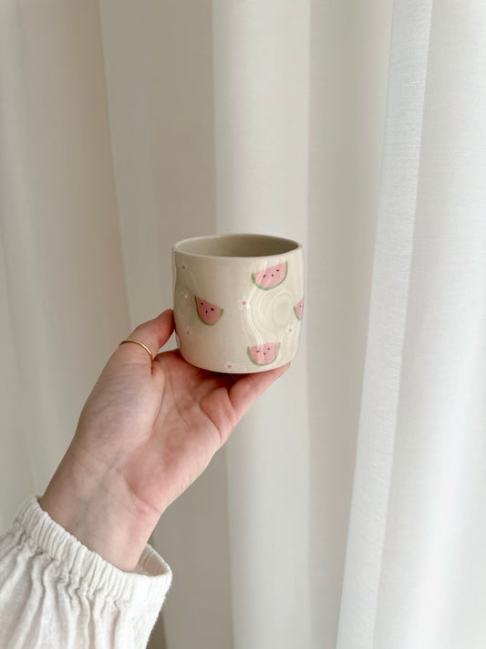 Cup with watermelons and flowers