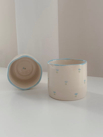 Cup with blue tulips